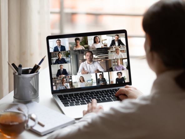 Person watching laptop with virtual meeting